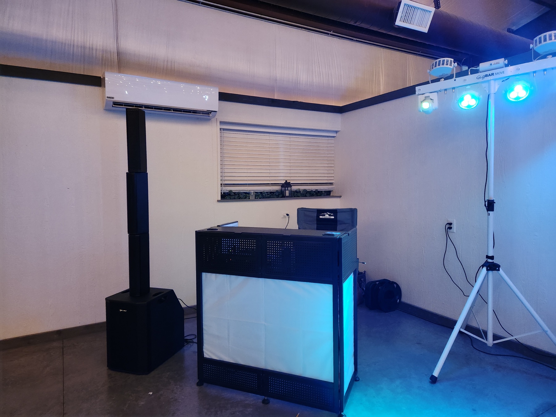 Off Key DJ booth and speaker system illuminated in blue