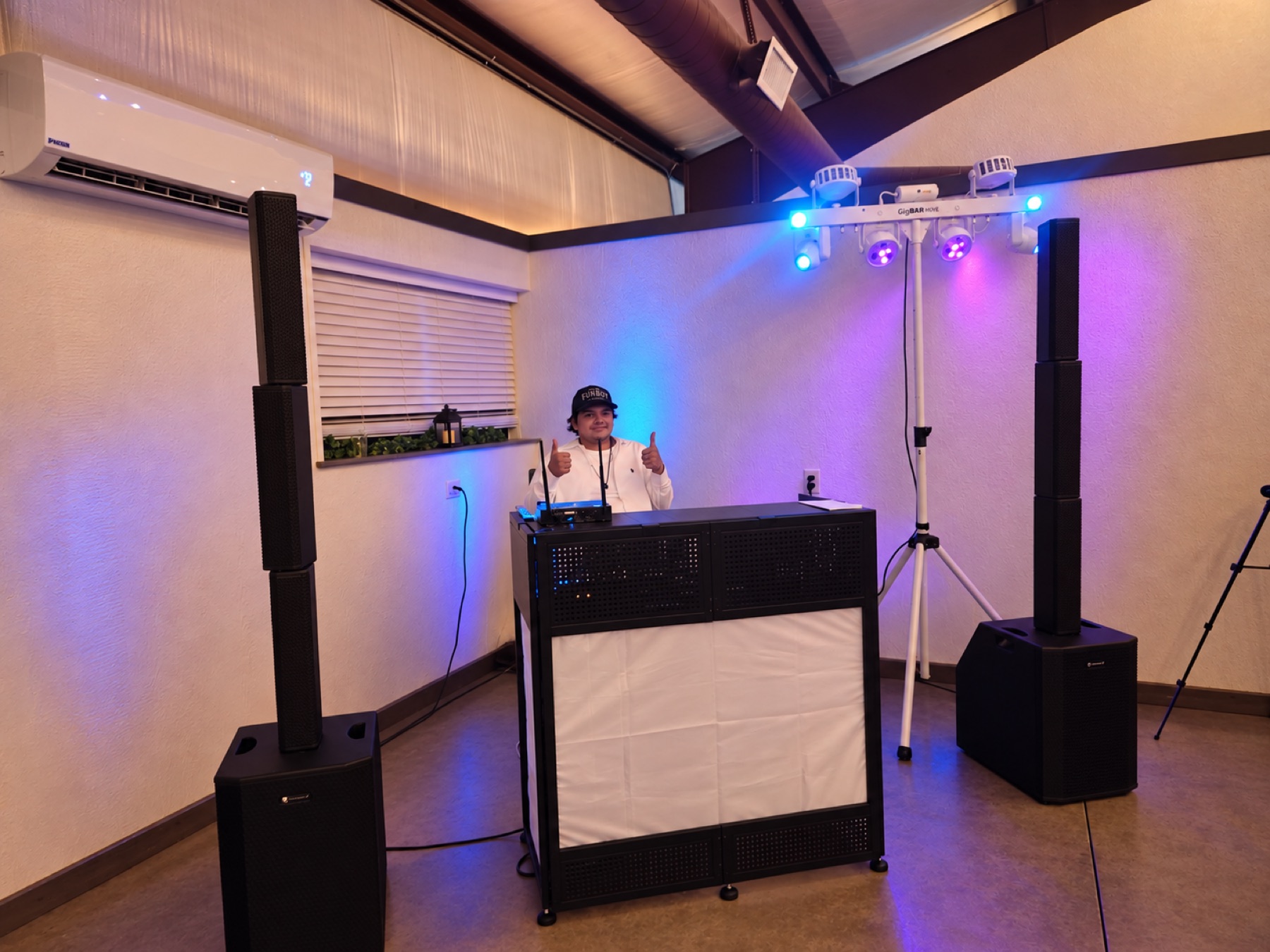 Off Key DJ booth with speakers and colorful event lighting