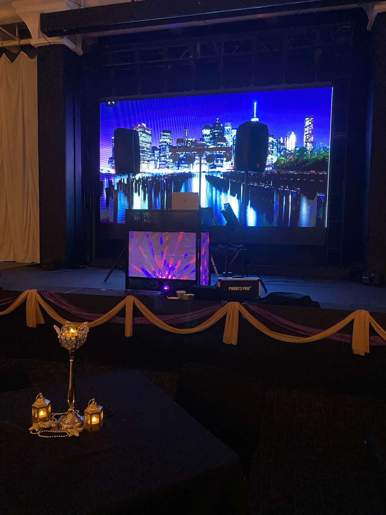 Off Key DJ stage setup with speakers, lighting, and a large video backdrop